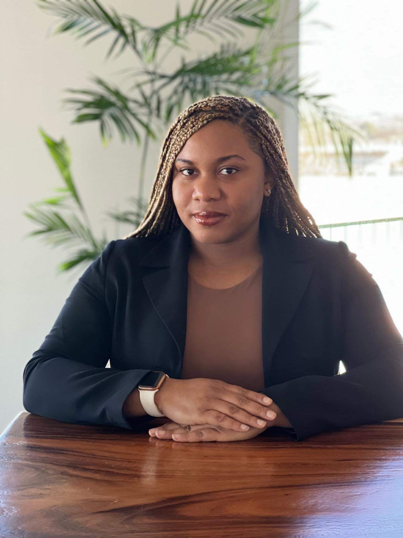 Human resources professional Alana Worth sits at a table with hands folded