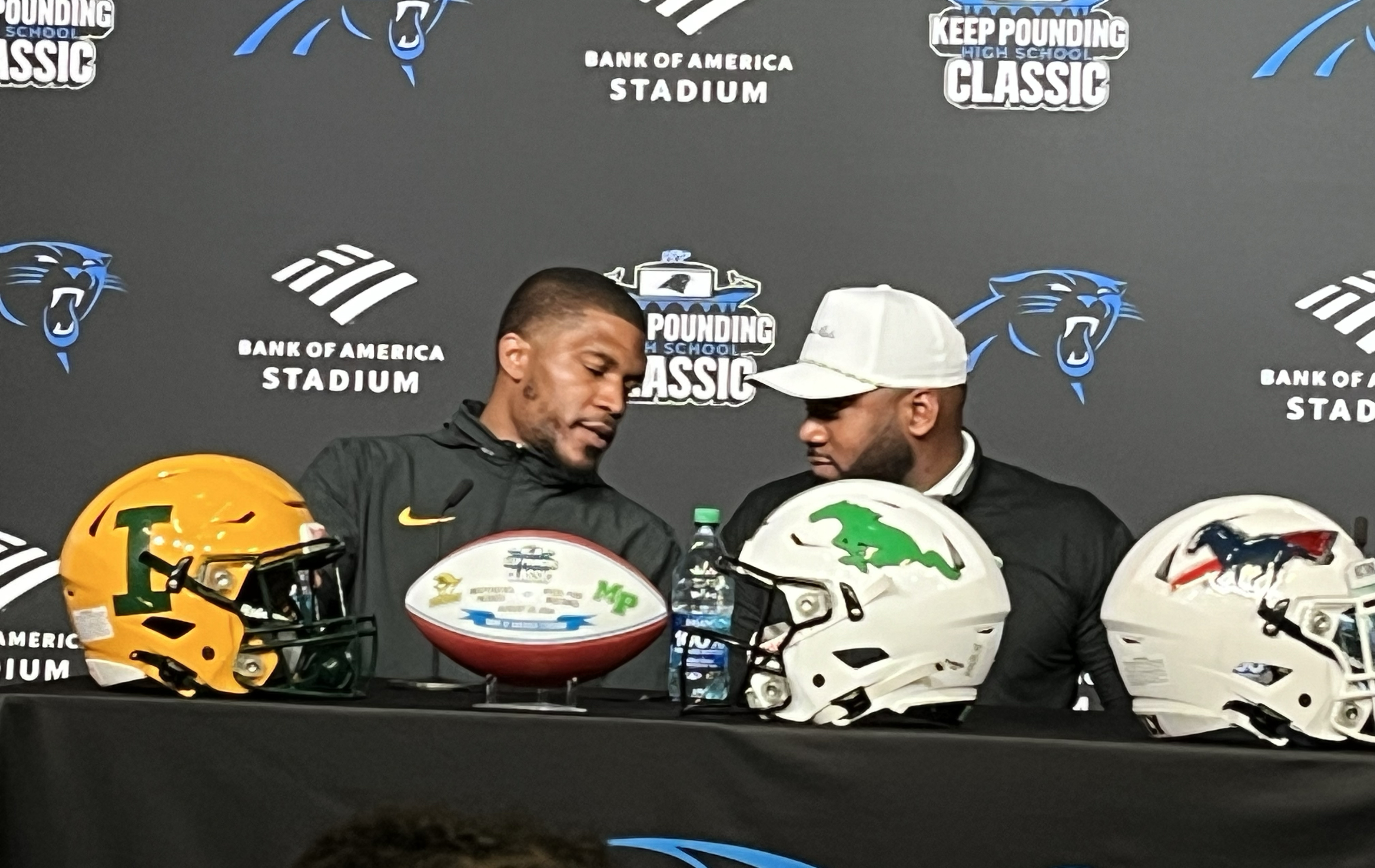 Independence High football coach D.J. McFadden and Myers Park coach Chris James  at Bank of America Stadium