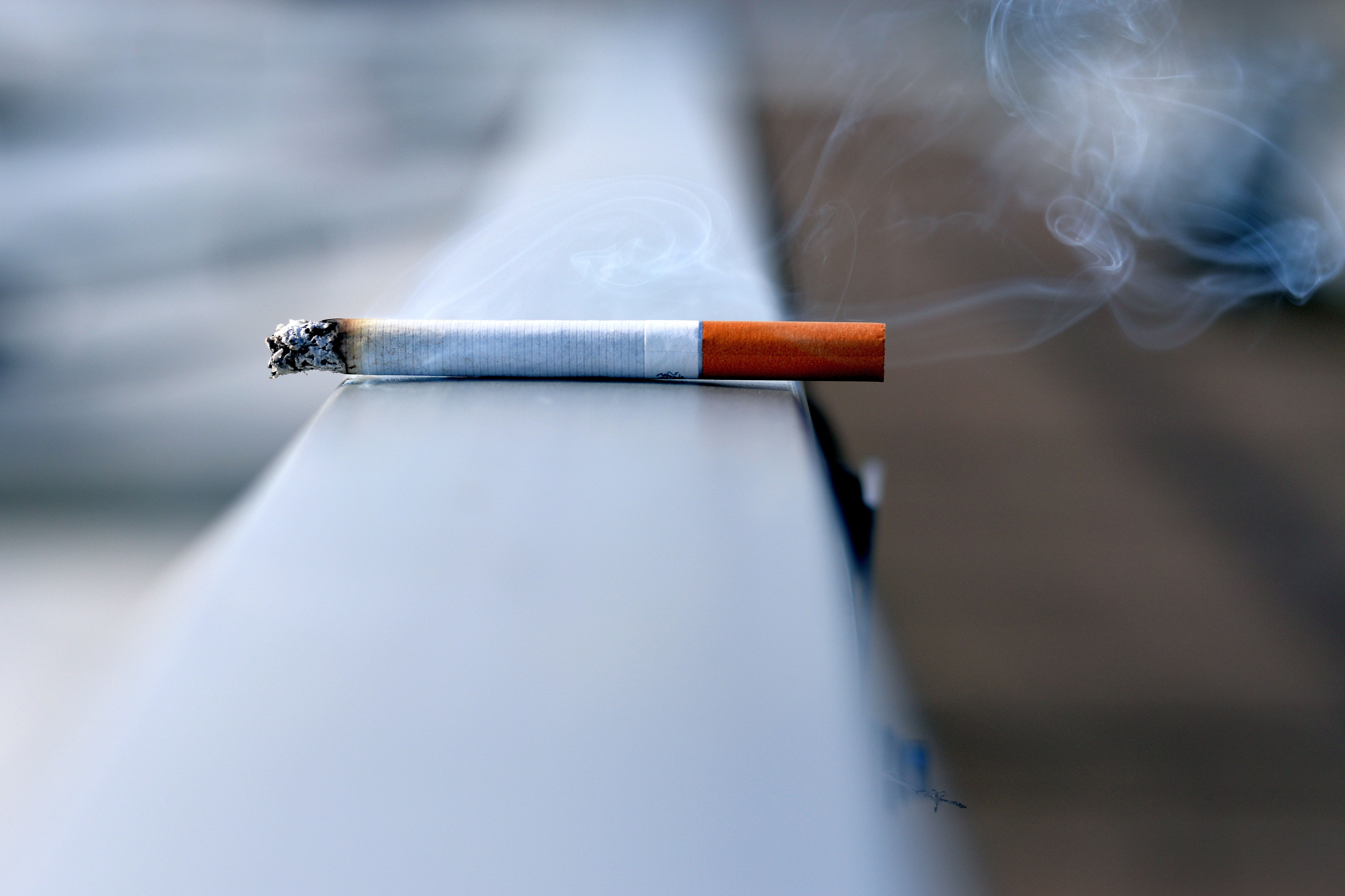 Cigarette burning on concrete step