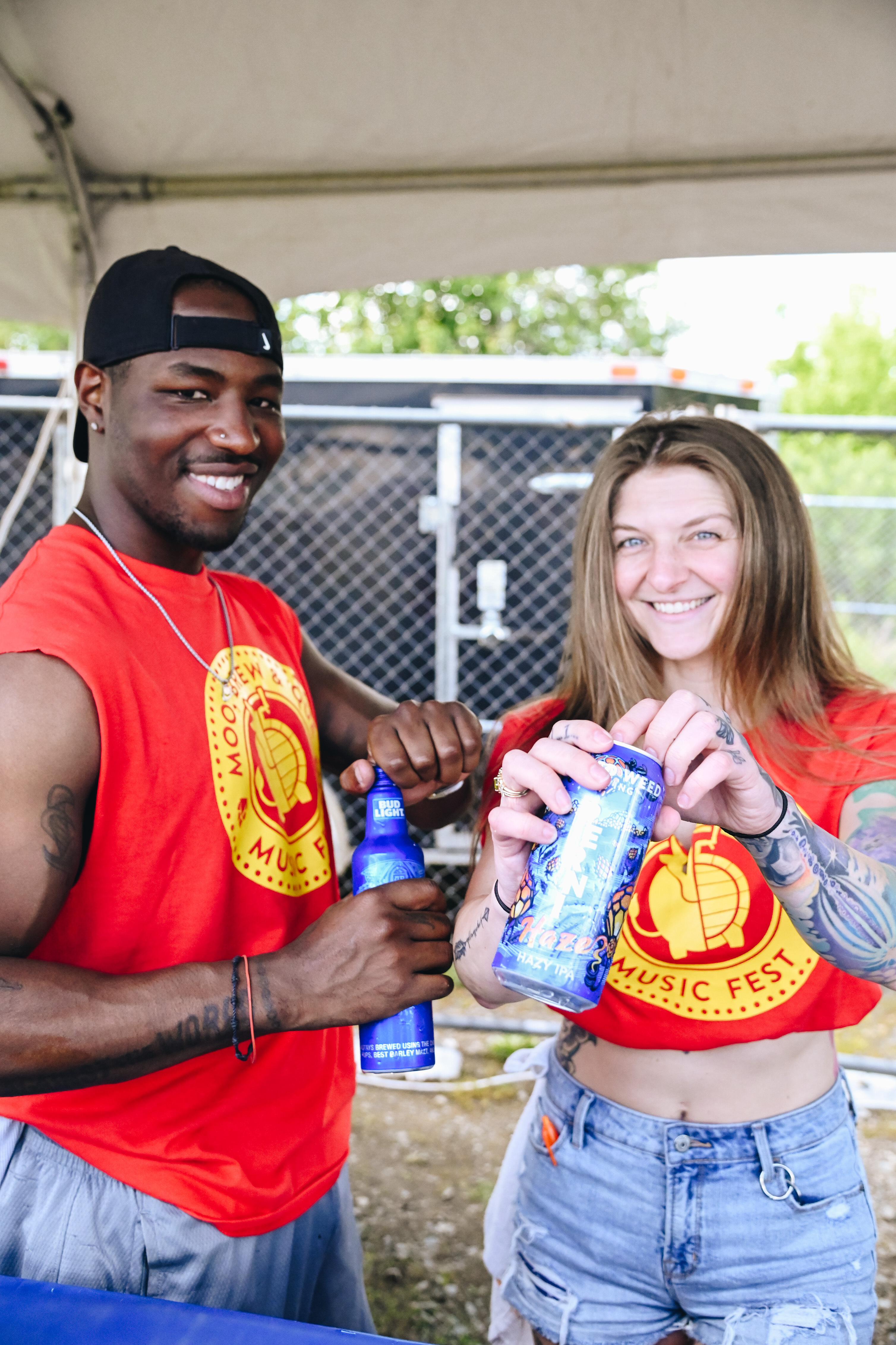 Patrons pose with beverages at Moo Brew and 'Que Music Festival in Charlotte
