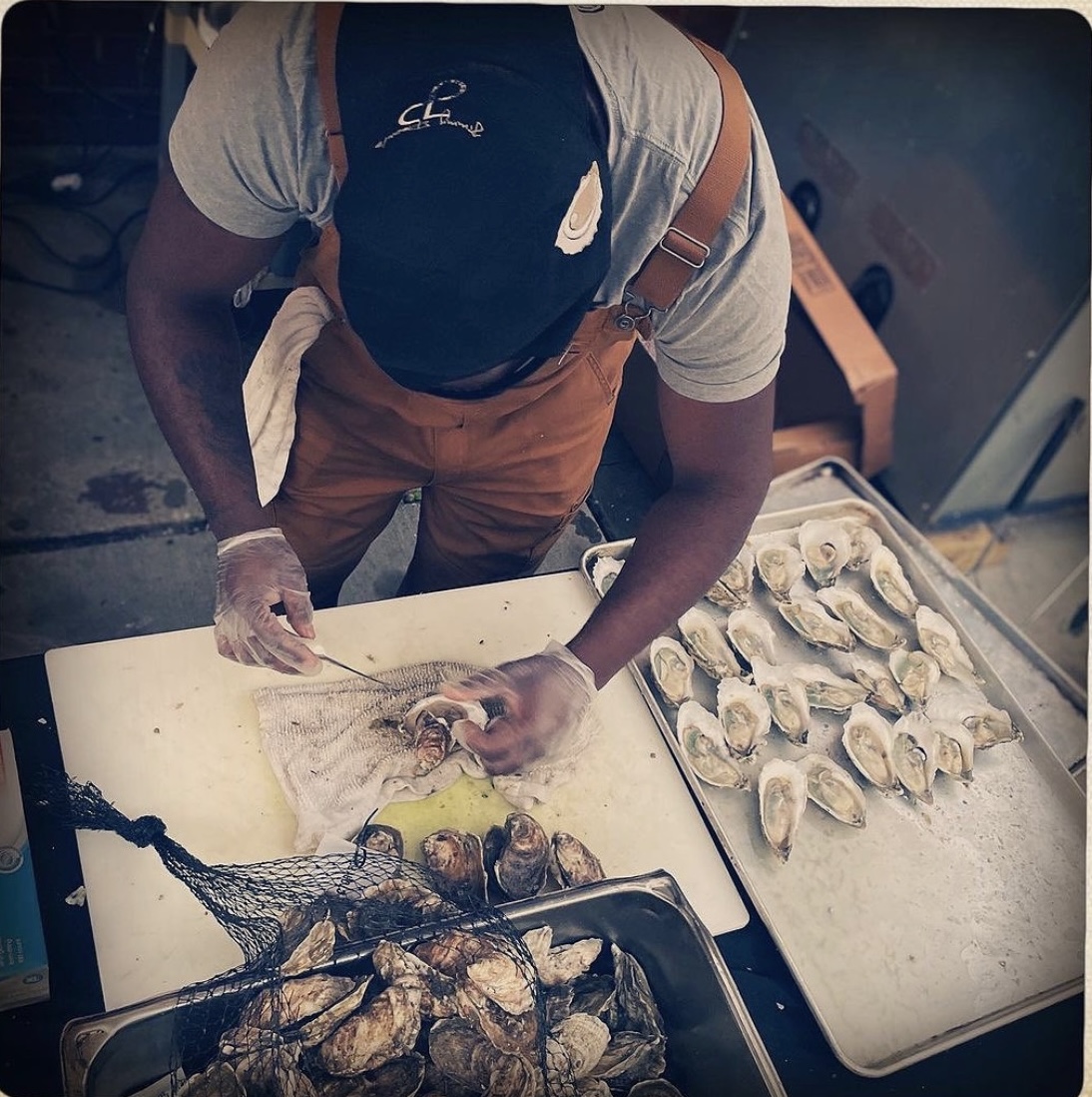 Jimmy Pearls co-owner Oscar Johnson prepares oysters for serving