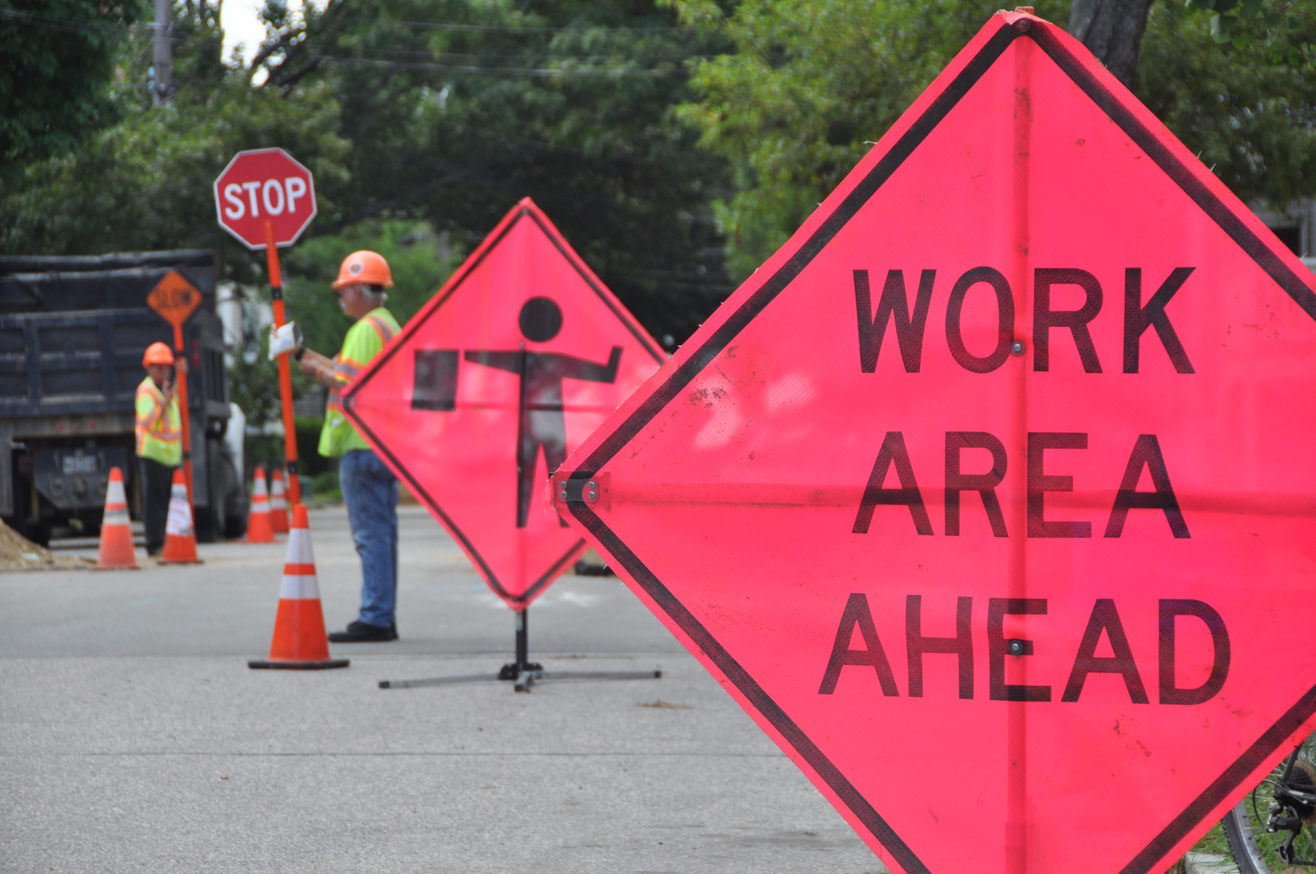 Highway construction crews show traffic signs