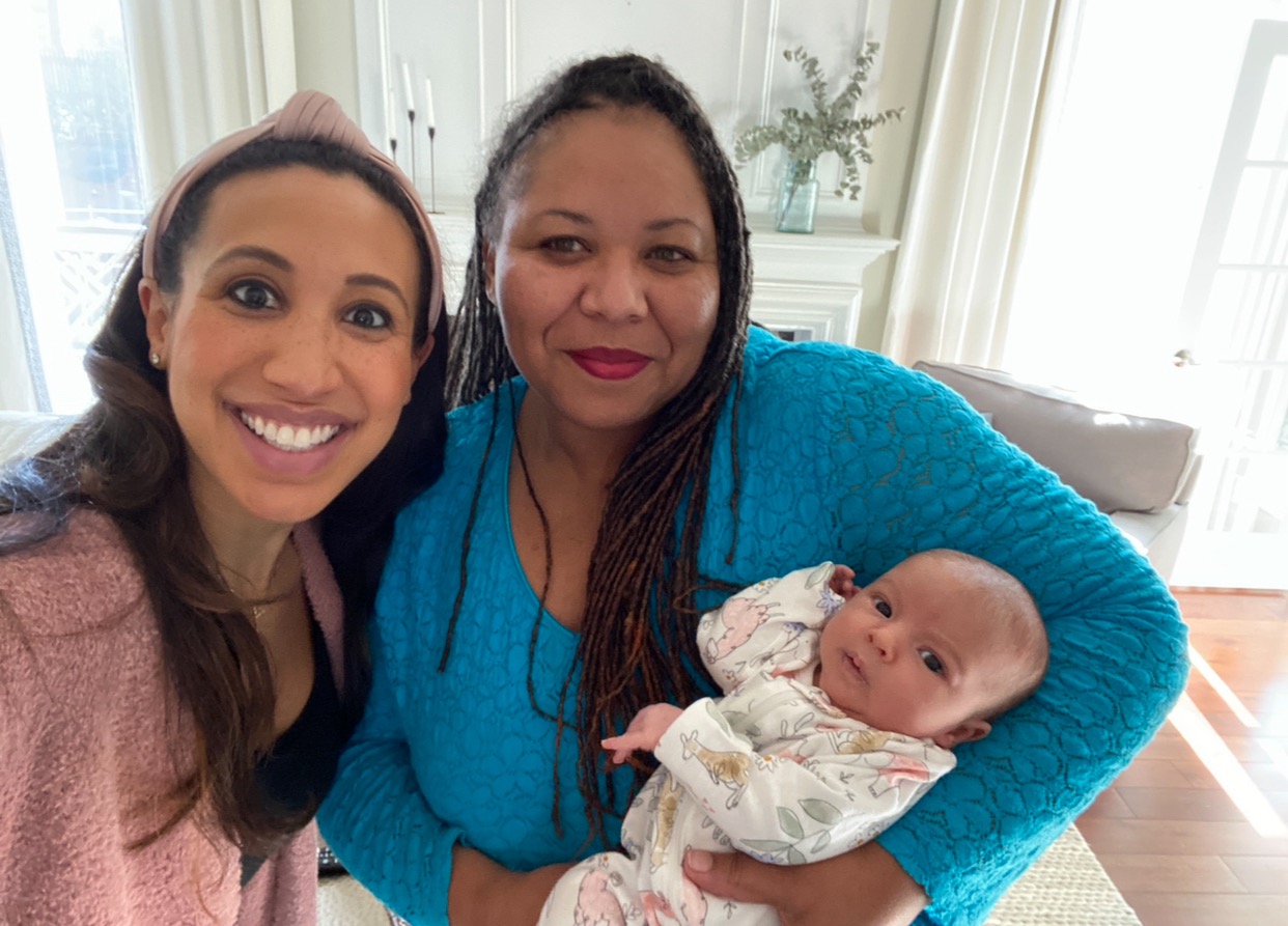 Doula Kira Kimble holds a newborn baby in Charlotte.